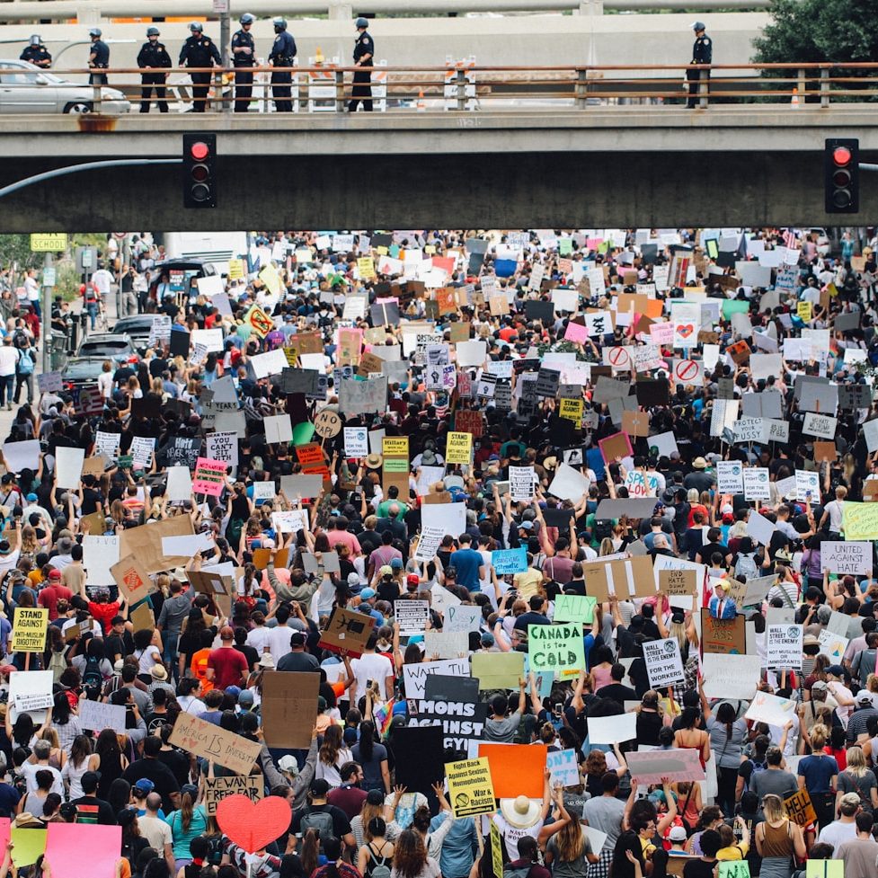 a large group of people holding up signs